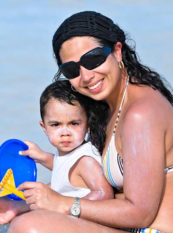 sunscreen applied on baby and mom